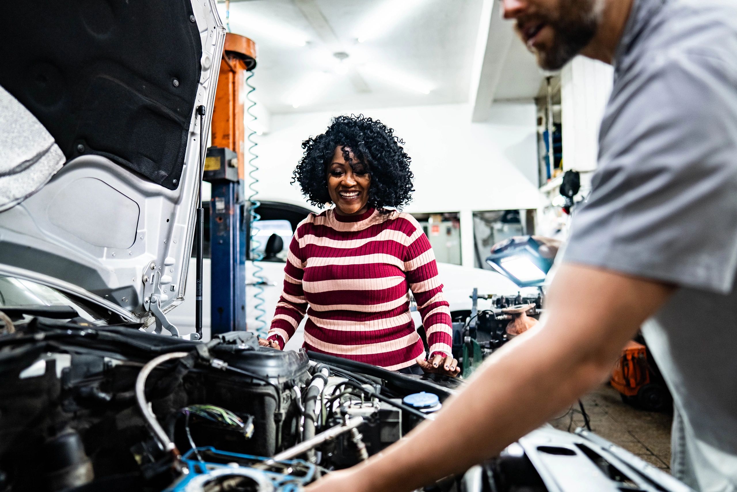 Customer discussing vehicle service with mechanic